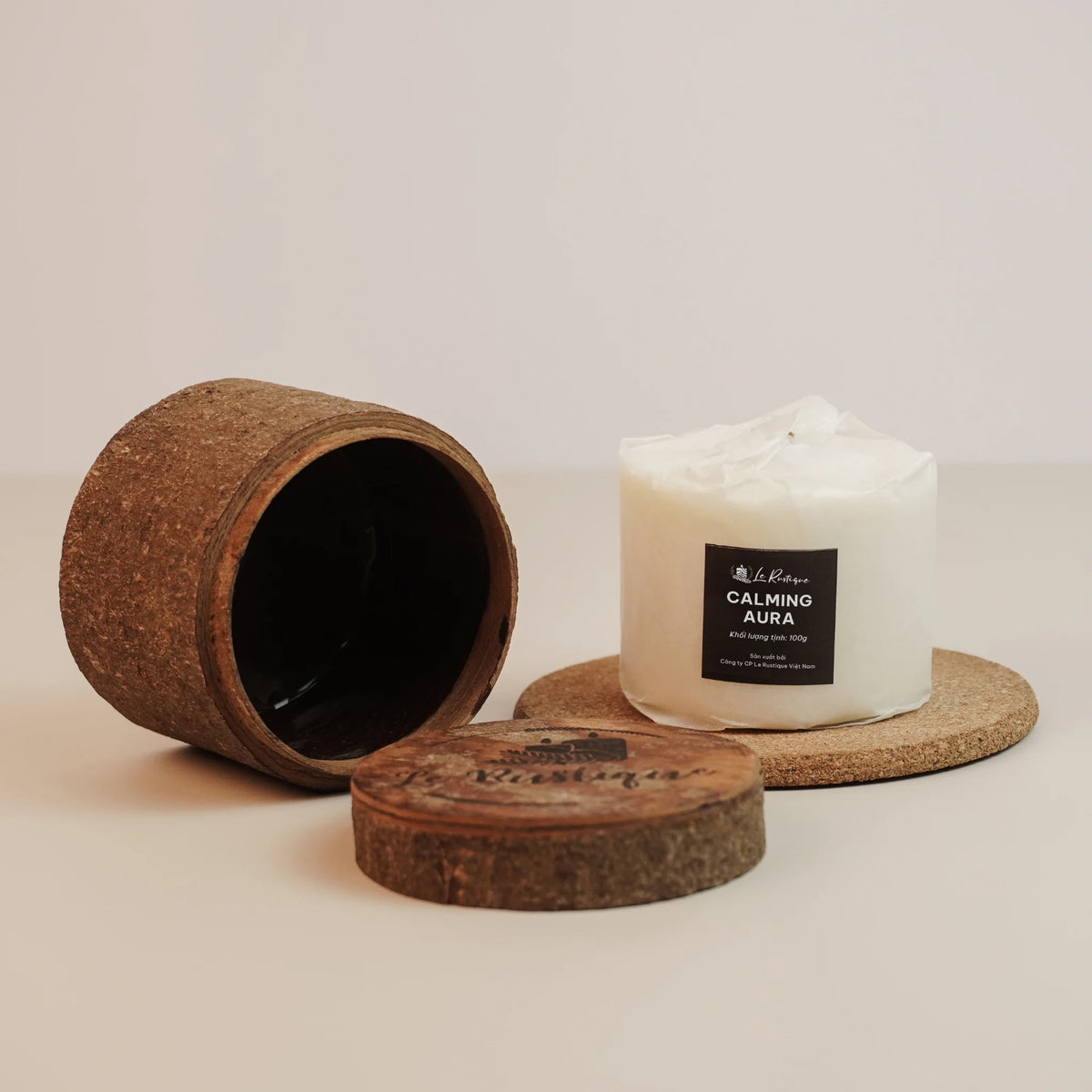 Soy wax candle refill labeled 'Calming Aura' with a cork lid and container on a light background